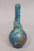 A JAPANESE TURQUOISE GLAZE PORCELAIN VASE with moulded dragon to the neck, (af), 25cm high.