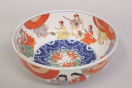 A JAPANESE IMARI PORCELAIN BOWL, painted with figures, the base with character mark, 24cm diameter.