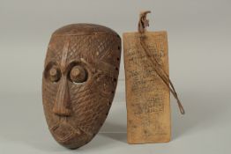 A 19TH CENTURY AFRICAN MASK, and a 19th North African calligraphic wooden panel, 28cm, (2).