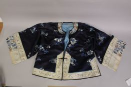 A CHINESE EMBROIDERED SILK SHIRT, with floral designs.