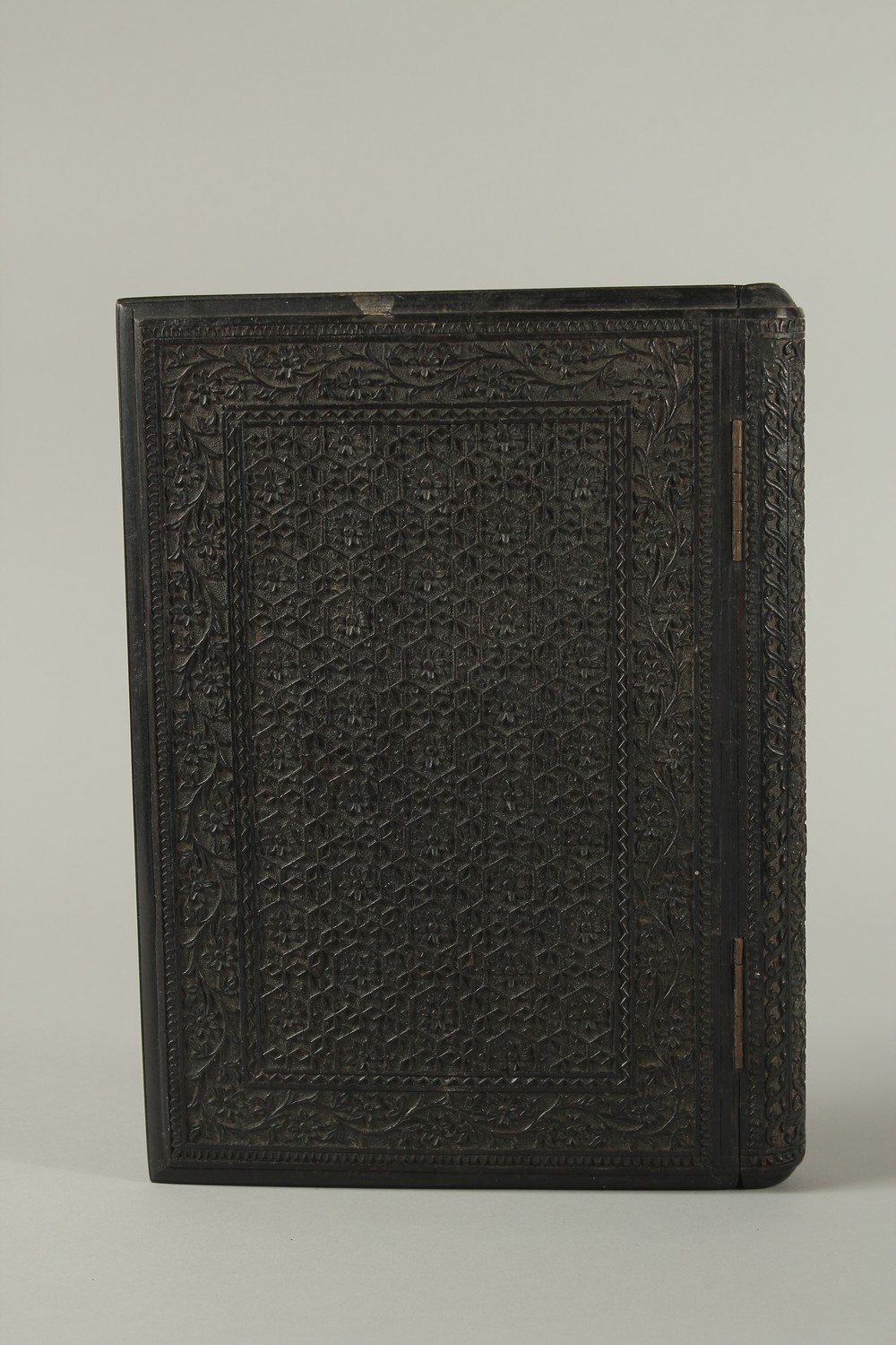 A MID 19TH CENTURY ANGLO INDIAN FINELY CARVED EBONY HINGED BOOK COVER, 30cm x 22cm. - Image 3 of 4