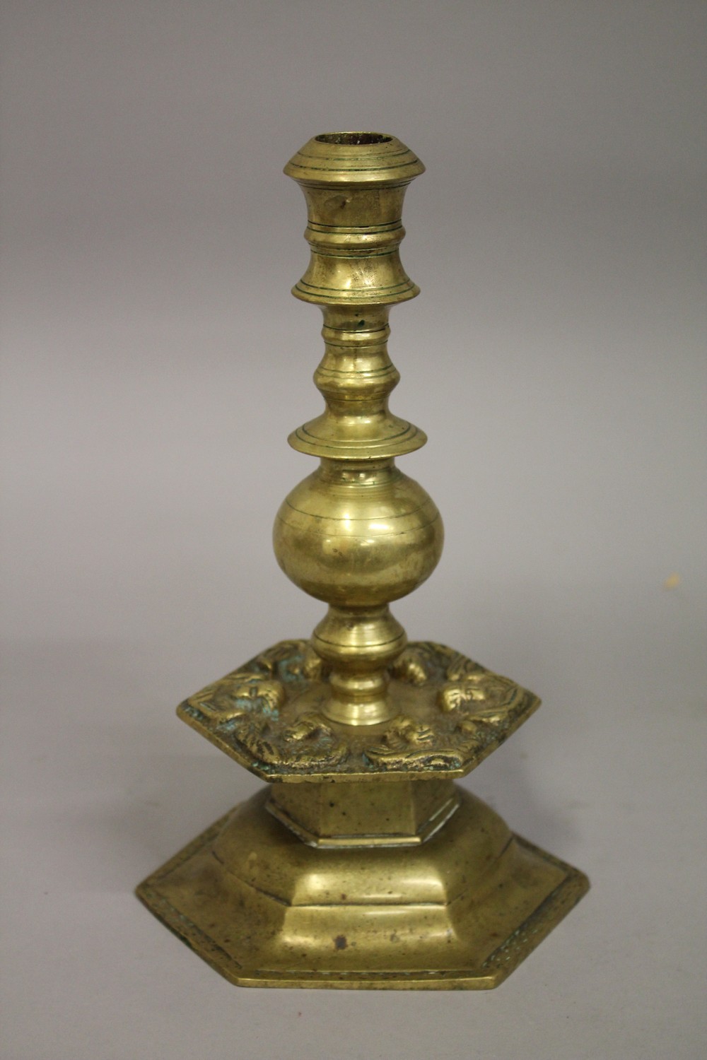 A 17TH-18TH FLEMISH BRASS CANDLESTICK, with cherubs, 28cm high.