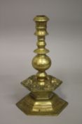 A 17TH-18TH FLEMISH BRASS CANDLESTICK, with cherubs, 28cm high.