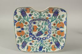 A TURKISH OTTOMAN IZNIK DESIGN BARBER'S WASH TRAY, 30cm x 28.5cm.