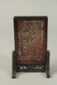 A CHINESE CARVED DRAGON SOAPSTONE MINIATURE SCREEN, inset within a hardwood frame with