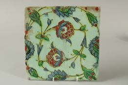 A FINE EARLY 17TH CENTURY OTTOMAN IZNIK POTTERY TILE, with floral decoration, 25cm x 25cm.