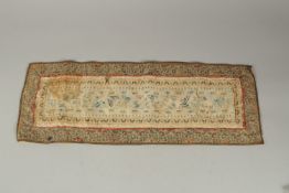 A CHINESE EMBROIDERED SILK PANEL.