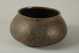 A 19TH CENTURY OR EARLIER PERSIAN ENGRAVED BRASS BOWL, with calligraphy panels, 22cm diameter.