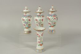 A FINE GARNITURE OF THREE CHINESE FAMILLE ROSE PORCELAIN JARS AND COVERS & TRUMPET VASE, each
