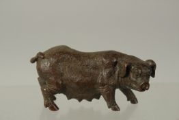 A BRONZE OKIMONO OF A SOW, 7.5cm long.