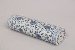 A CHINESE BLUE AND WHITE PORCELAIN WRIST REST, with lotus decoration and pierced ends, 15cm long.