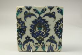 A 17TH CENTURY SYRIA DAMASCUS GLAZED POTTERY TILE, 23cm x 23cm.