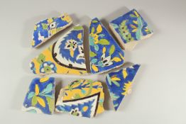 A COLLECTION OF SEVEN 17TH CENTURY PERSIAN SAFAVID TILE FRAGMENTS, largest 23cm wide (7).