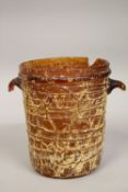 A VERY LARGE AND UNUSUAL POSSIBLY EARLY ISLAMIC ROMAN STYLE AMBER GLASS TWIN HANDLE BUCKET, 24cm