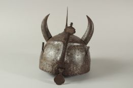 AN EARLY 19TH CENTURY PERSIAN QAJAR SILVER INLAID STEEL HELMET, shaped with a face and horns, with