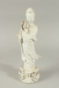 A BLANC-DE-CHINE PORCELAIN FIGURE OF GUANYIN STOOD UPON A LILYPAD, with fine floral details to the