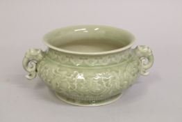 A CHINESE CELADON GLAZE PORCELAIN TWIN HANDLE CENSER BURNER, with carved dragon and phoenix, 21cm