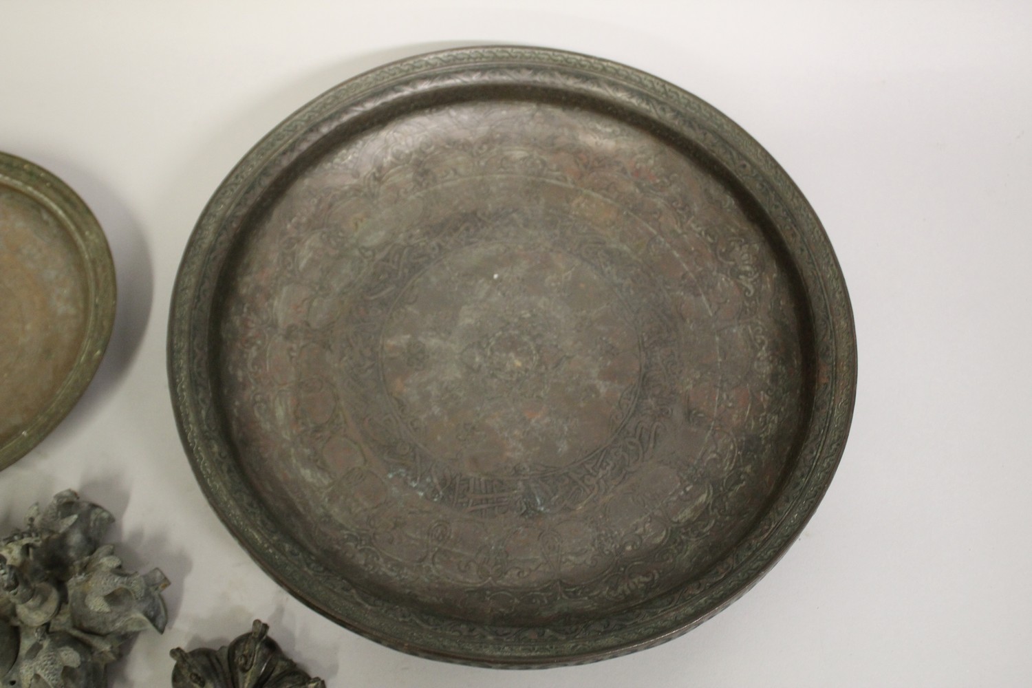 A 17TH CENTURY PERSIAN SAFAVID ENGRAVED COPPER DISH, together with a smaller Persian dish, and two - Image 2 of 5