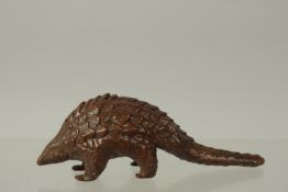 A BRONZE OKIMONO OF A PANGOLIN, 10cm long.