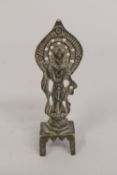 A SMALL BRONZE FIGURE OF A DEITY, raised on four feet, 13cm high.