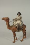 A 19TH CENTURY SIGNED OREINTALIST BERGMAN COLD PAINTED BRONZE CAMEL AND RIDER, 21cm high.