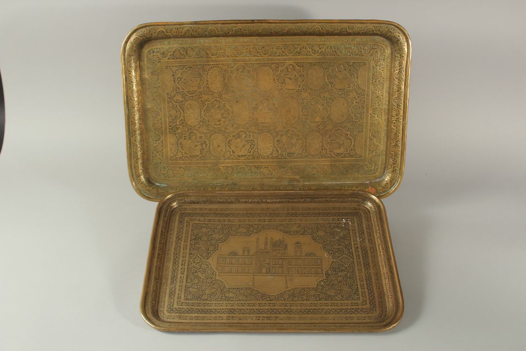 TWO 19TH CENTURY PERSIAN QAJAR ENGRAVED BRASS TRAYS, one depicting seated figures and musicians, the - Image 1 of 3