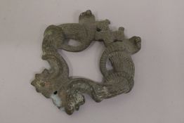 AN 18TH-19TH CENTURY INDIAN BRASS OR BRONZE DOOR KNOCKER, depicting birds and cobras, 10cm x 10cm.