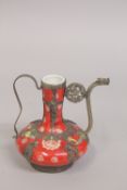 A SMALL CHINESE RED VASE WITH METAL MOUNTS, the base with impressed marks, 14cm high.