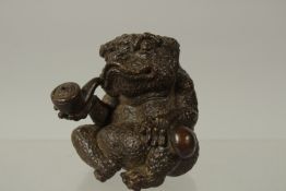 A BRONZE OKIMONO OF A TOAD smoking a pipe, 7cm high.