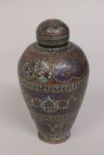 A 19TH CENTURY INDIAN KASHMIRI ENAMELLED COPPER LIDDED JAR, 17cm high.
