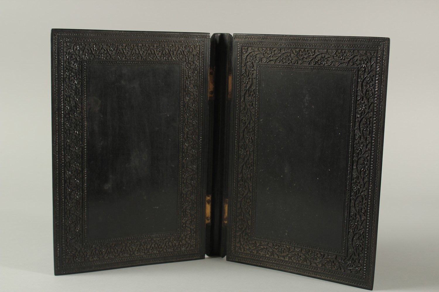 A MID 19TH CENTURY ANGLO INDIAN FINELY CARVED EBONY HINGED BOOK COVER, 30cm x 22cm. - Image 4 of 4