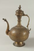 A FINELY ENGRAVED 19TH CENTURY INDIAN BRASS EWER, 39cm high.
