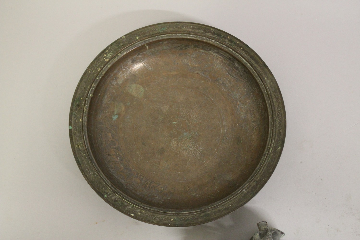 A 17TH CENTURY PERSIAN SAFAVID ENGRAVED COPPER DISH, together with a smaller Persian dish, and two - Image 3 of 5