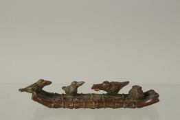 A BRONZE OKIMONO OF THREE OSPREY on a bamboo raft, 10cm long.