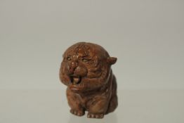 A BRONZE OKIMONO OF A STYLISED TIGER, 4cm high.