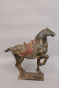 A LARGE 19TH CENTURY CHINESE GILDED CARVED WOOD TANG HORSE, 51cm high, 53cm long.