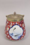 A JAPANESE NISHIKIDE WARE PORCELAIN JAR, with metal mounted lid and handle, painted with panels of