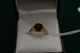 A 14ct gold, garnet and diamond ring, size P.