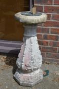 A reconstituted stone sun dial.