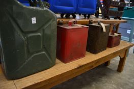 A Shell Aviation Spirit fuel can and three other cans.