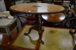 A mahogany oval tripod occasional table.