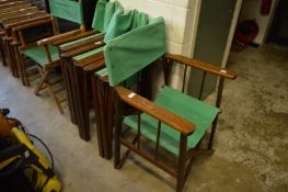 A set of four hardwood and green canvas folding directors style chairs.
