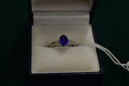 A 9ct gold ring set with a blue stone, size H.