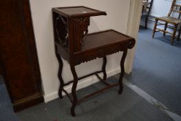 A Chinese two-tier carved rosewood stand.