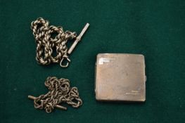 Two silver watch chains and a silver compact.
