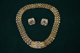 A gilt metal diamante necklace and ear clips.