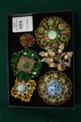 Six decorative brooches.