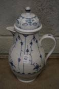 A Volkstedt coffee pot and cover decorated with blue flowers.