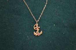 A 9ct gold chain with anchor pendant.