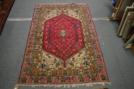 A Persian style rug, red ground, decorated with figures and animals 180cm x 120cm.